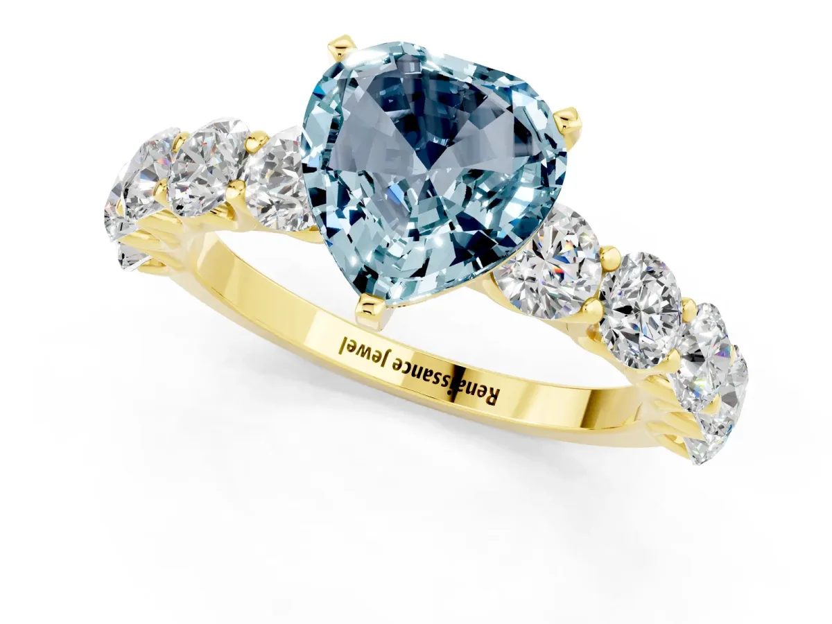 Heart Cut Aquamarine Prong Setting with Side Stones on a Pave Band Yellow gold