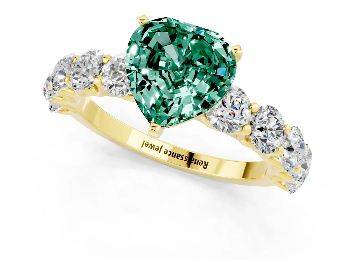 Heart Cut Green Sapphire Prong Setting with Side Stones on a Pave Band Yellow gold