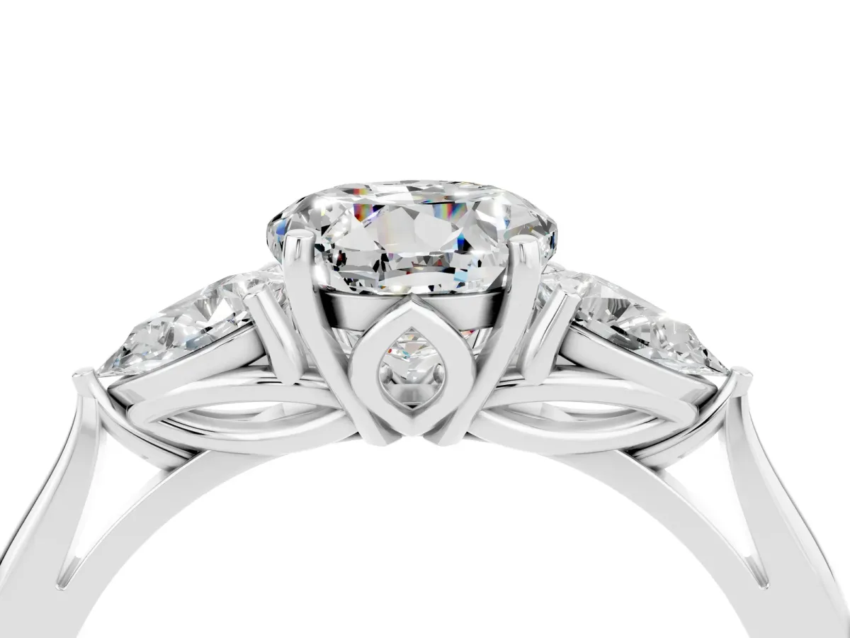 Three-Stone Round Cut Moissanite Ring with Pear Side Stones in Four-Prong Setting Platinum
