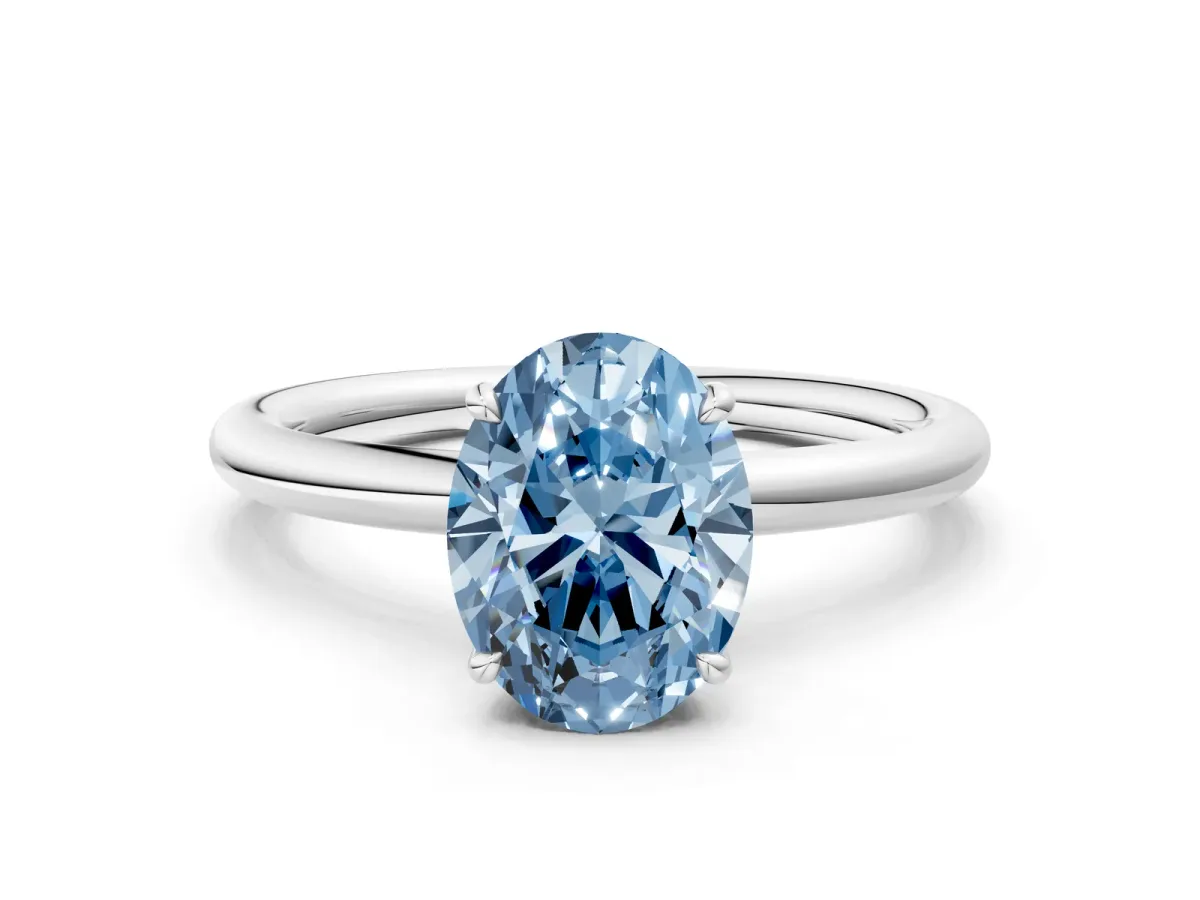 Fancy Blue Oval Cut Diamond Solitaire Ring with Thin Band and Four-Prong Setting White gold