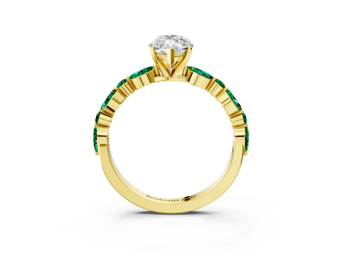 Marquise Cut Diamond Ring with Marquise and Round Emerald Side Stones and Four-Prong Setting Yellow gold