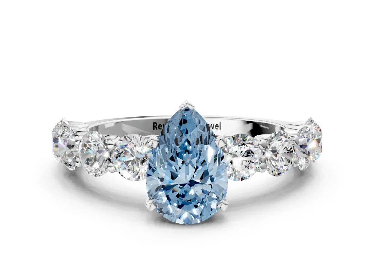 Fancy Blue Pear Cut Diamond Prong Setting with Side Stones on a Pave Band Silver