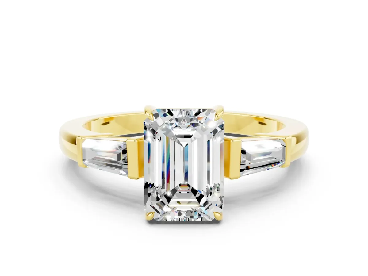 Emerald Cut Moissanite Three-Stone Ring with Tapered Baguette Side Stones and Prong Setting Yellow gold