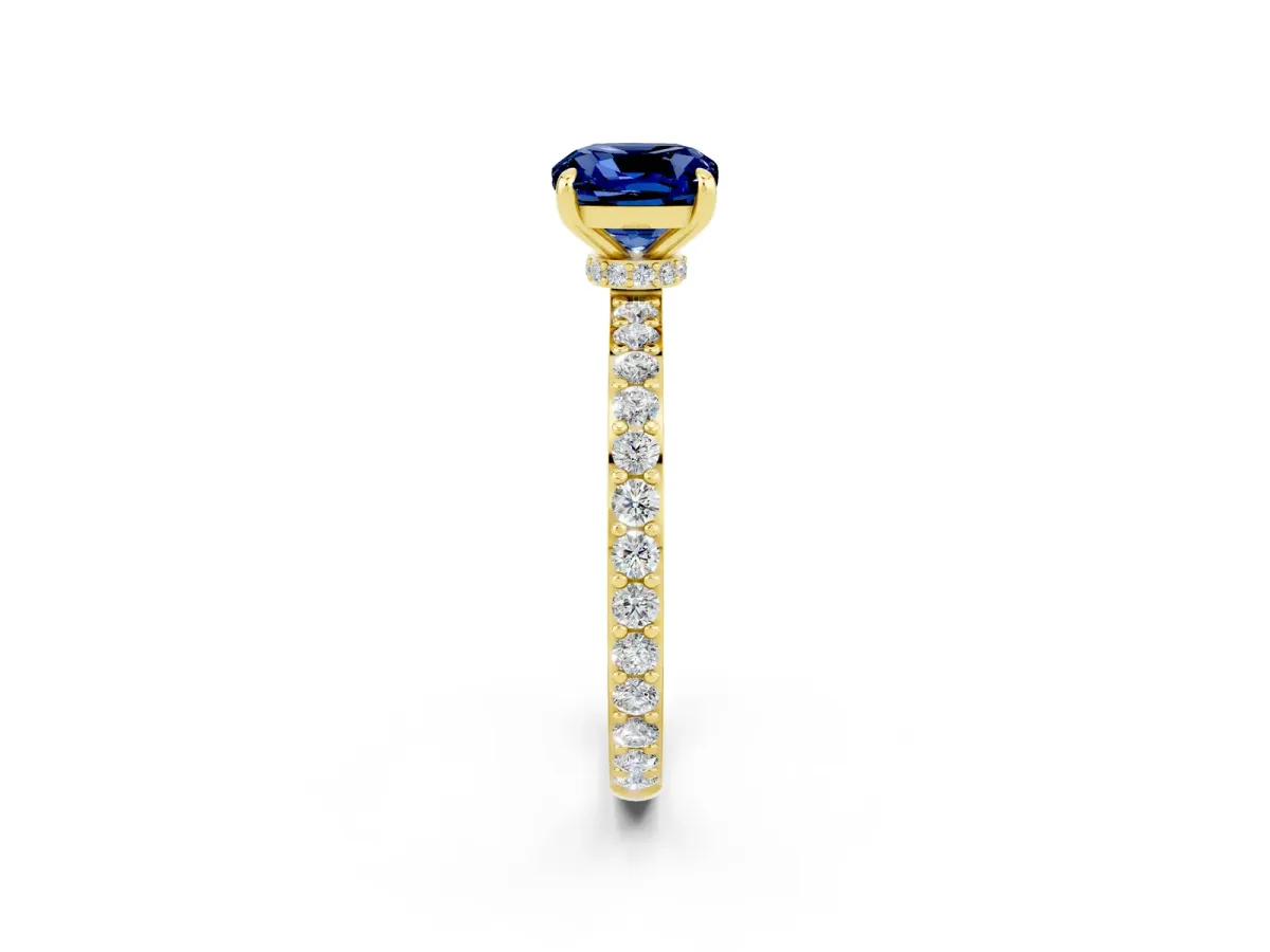 Cushion Cut Blue Sapphire Solitaire Engagement Ring with Pavé Band and Four-Prong Setting Yellow gold