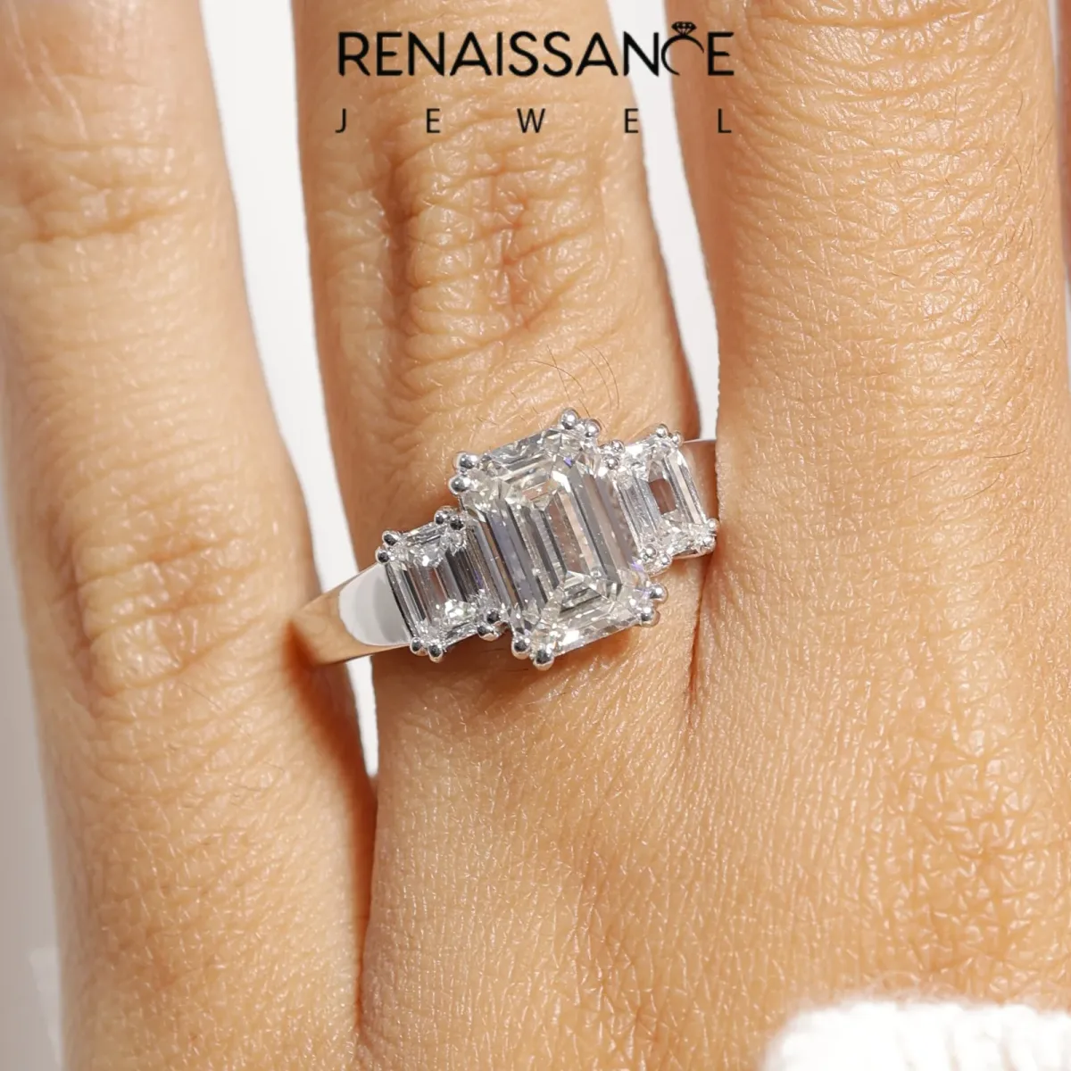 Three-Stone Emerald Cut Cut Diamond Ring with Channel Set Band and Four-Prong Setting Platinum
