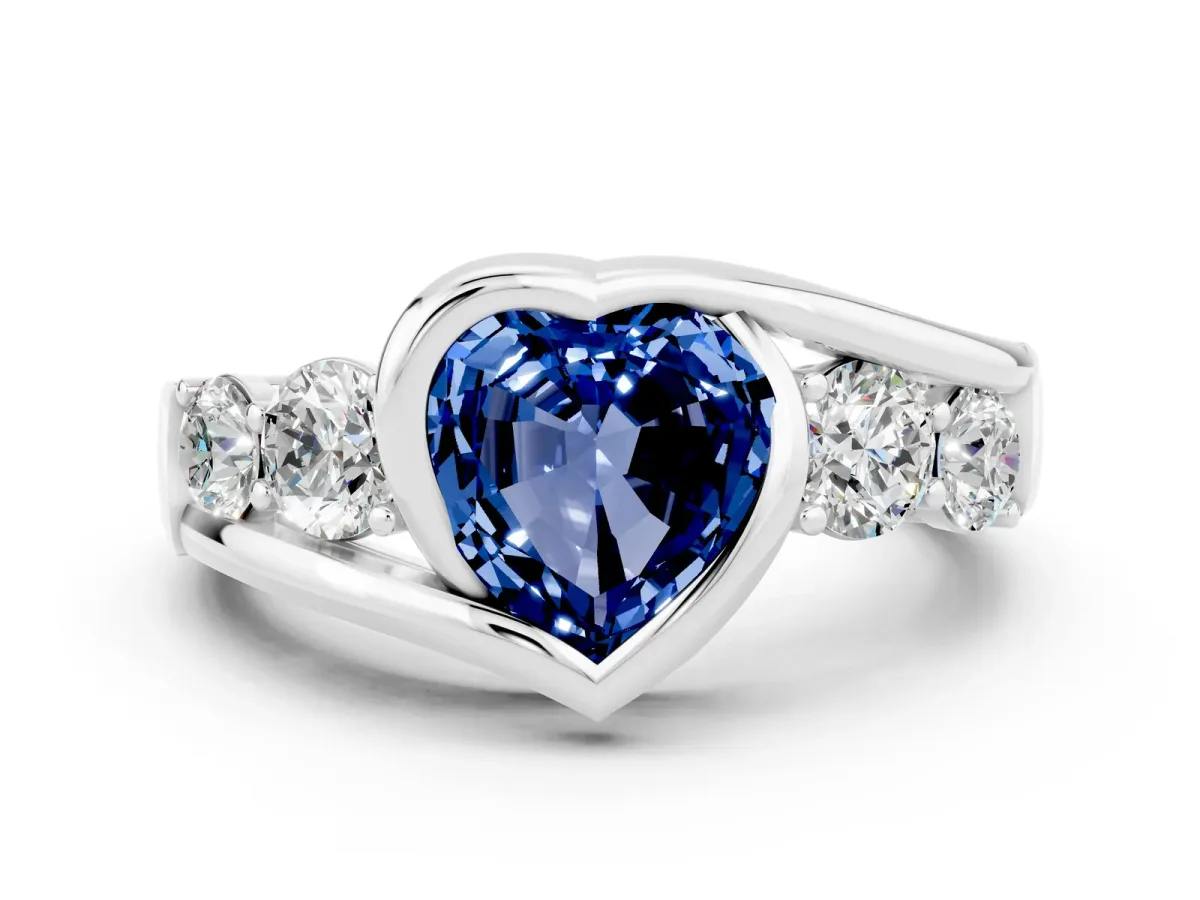 Bezel Set Heart Cut Blue Sapphire Bypass Ring with Round Accents Platinum