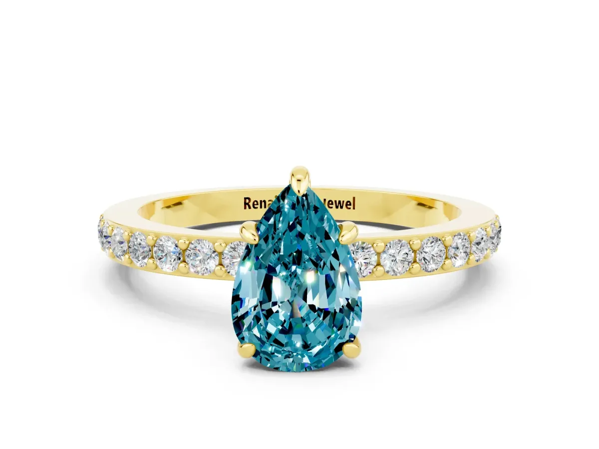 Pear Cut Blue Topaz Solitaire Engagement Ring with Pavé Band and Four-Prong Setting Yellow gold