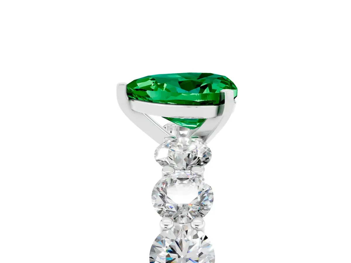 Heart Cut Emerald Prong Setting with Side Stones on a Pave Band Silver