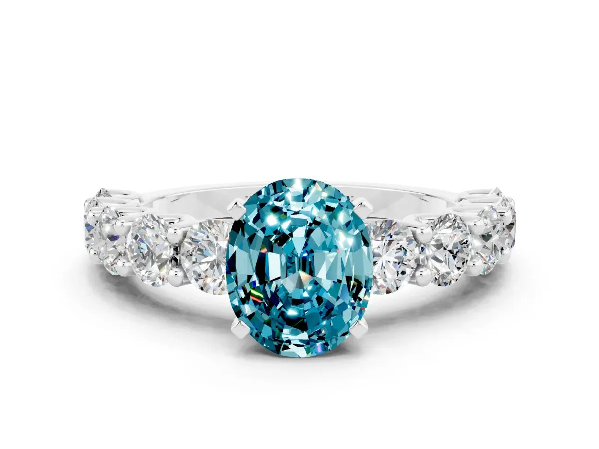 Oval Cut Blue Topaz Prong Setting with Side Stones on a Pave Band Silver
