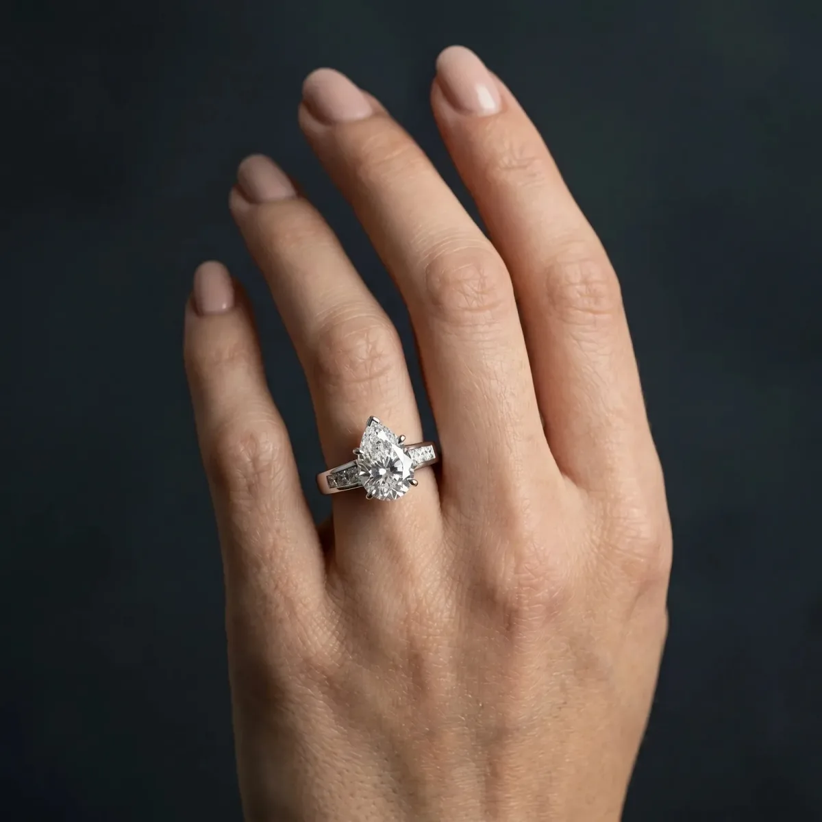Pear Cut Cut Channel Set Solitaire Ring with Four-Prong Setting White gold
