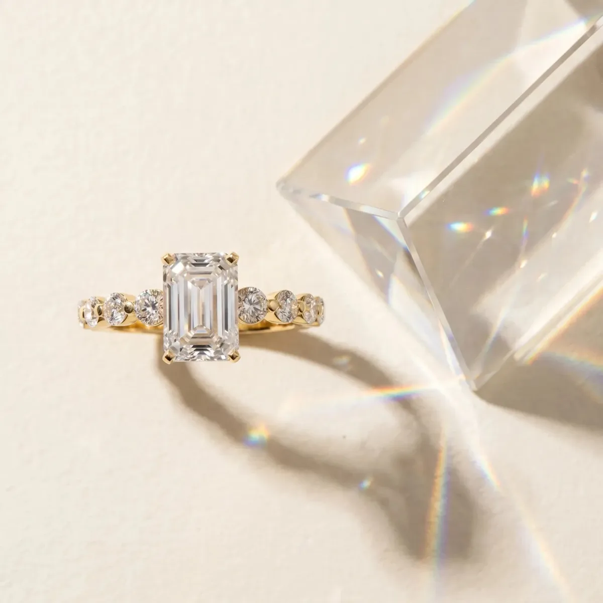 Emerald Cut Solitaire Diamond Ring with Pave Band and Four-Prong Setting Yellow gold