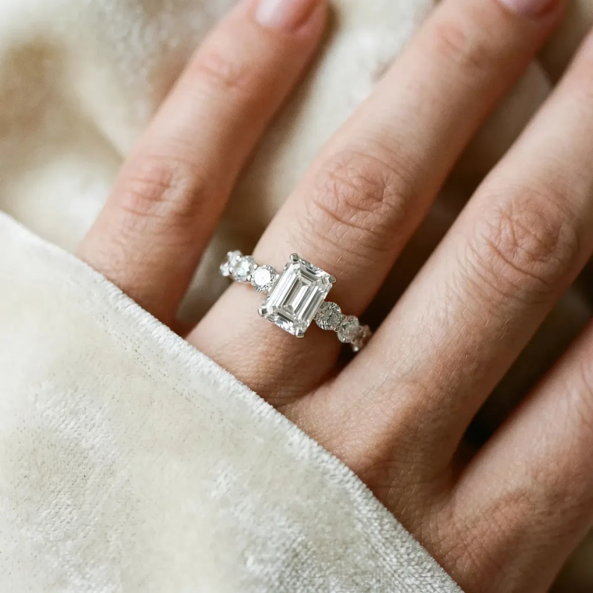 Emerald Cut Diamond Prong Setting with Side Stones on a Pave Band Silver