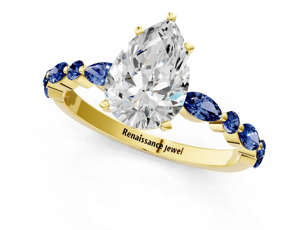 Pear Cut Diamond Ring with Marquise and Round Blue Sapphire Side Stones and Four-Prong Setting Yellow gold