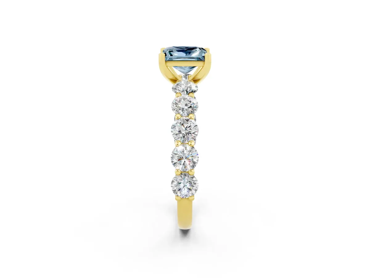 Princess Cut Aquamarine Prong Setting with Side Stones on a Pave Band Yellow gold