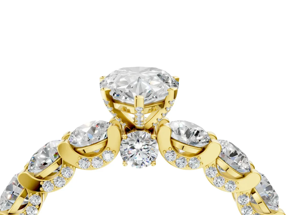 Pear Cut Diamond Side Stone Engagement Ring with Four-Prong Setting Yellow gold