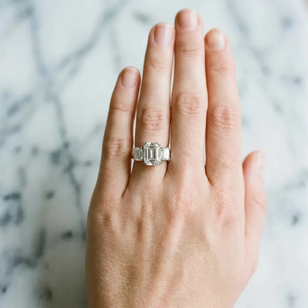 Three-Stone Emerald Cut Cut Diamond Ring with Channel Set Band and Four-Prong Setting Platinum
