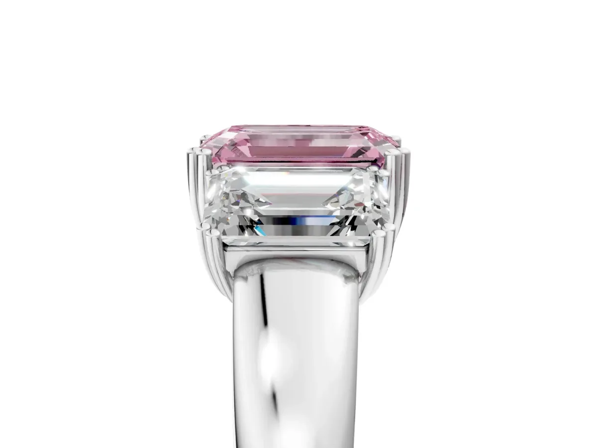 Fancy Pink Three-Stone Emerald Cut Cut Diamond Ring with Channel Set Band and Four-Prong Setting Platinum