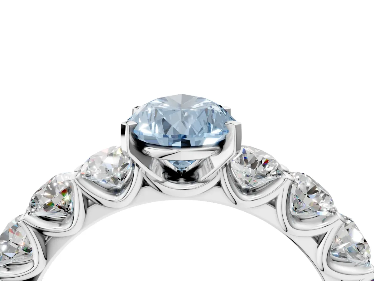 Fancy Blue Pear Cut Diamond Prong Setting with Side Stones on a Pave Band Silver
