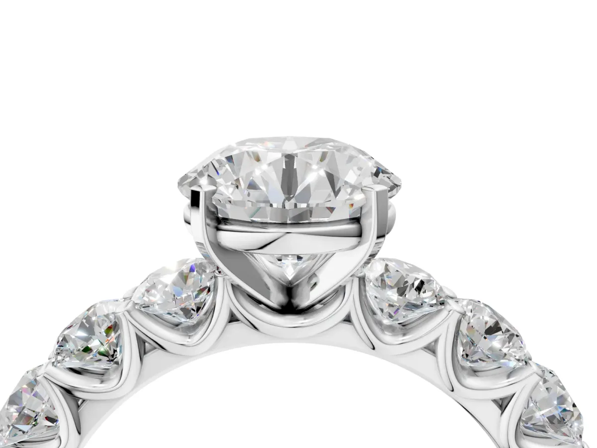 Round Cut Diamond Prong Setting with Side Stones on a Pave Band White gold