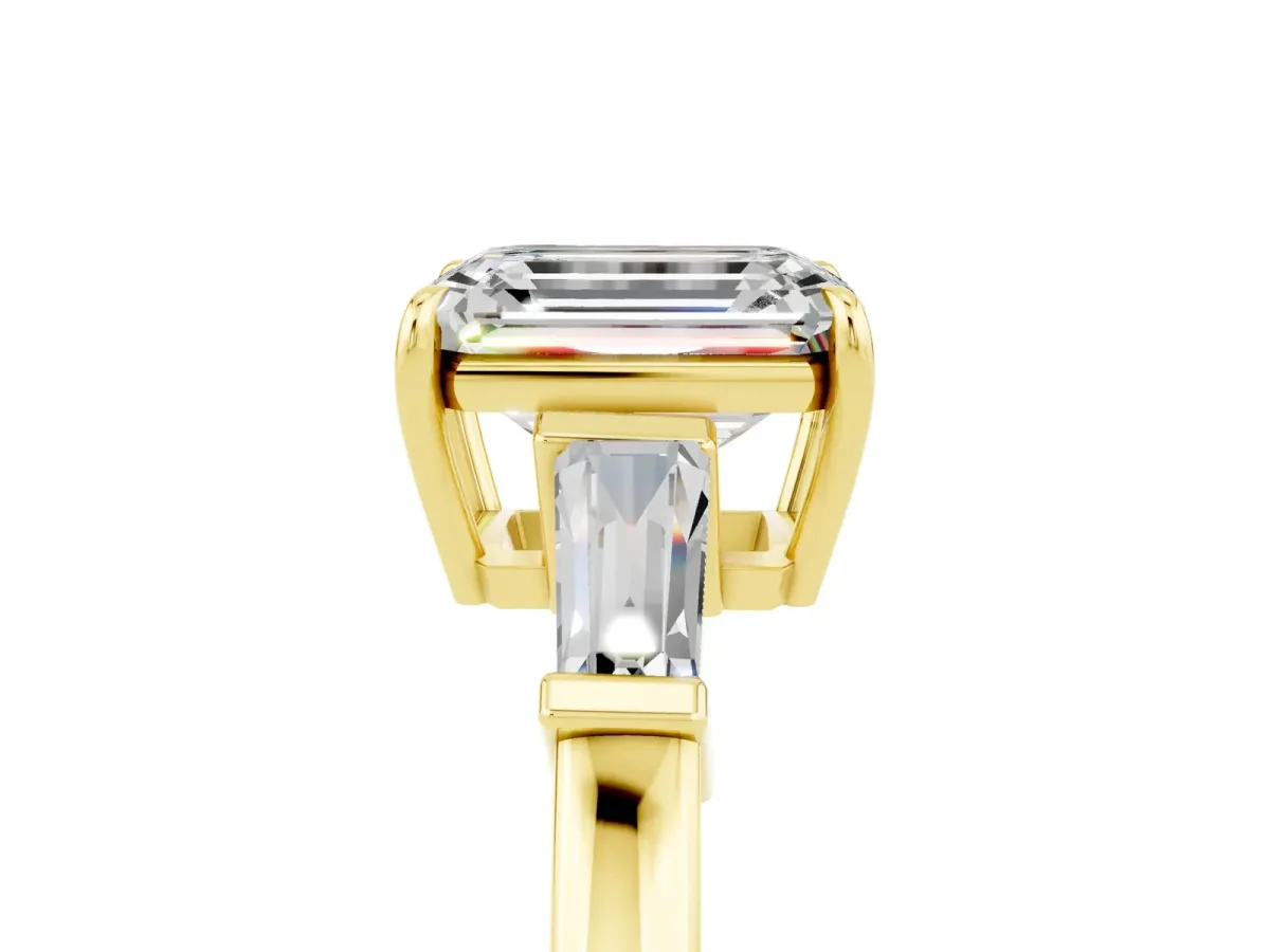 Emerald Cut Moissanite Three-Stone Ring with Tapered Baguette Side Stones and Prong Setting Yellow gold