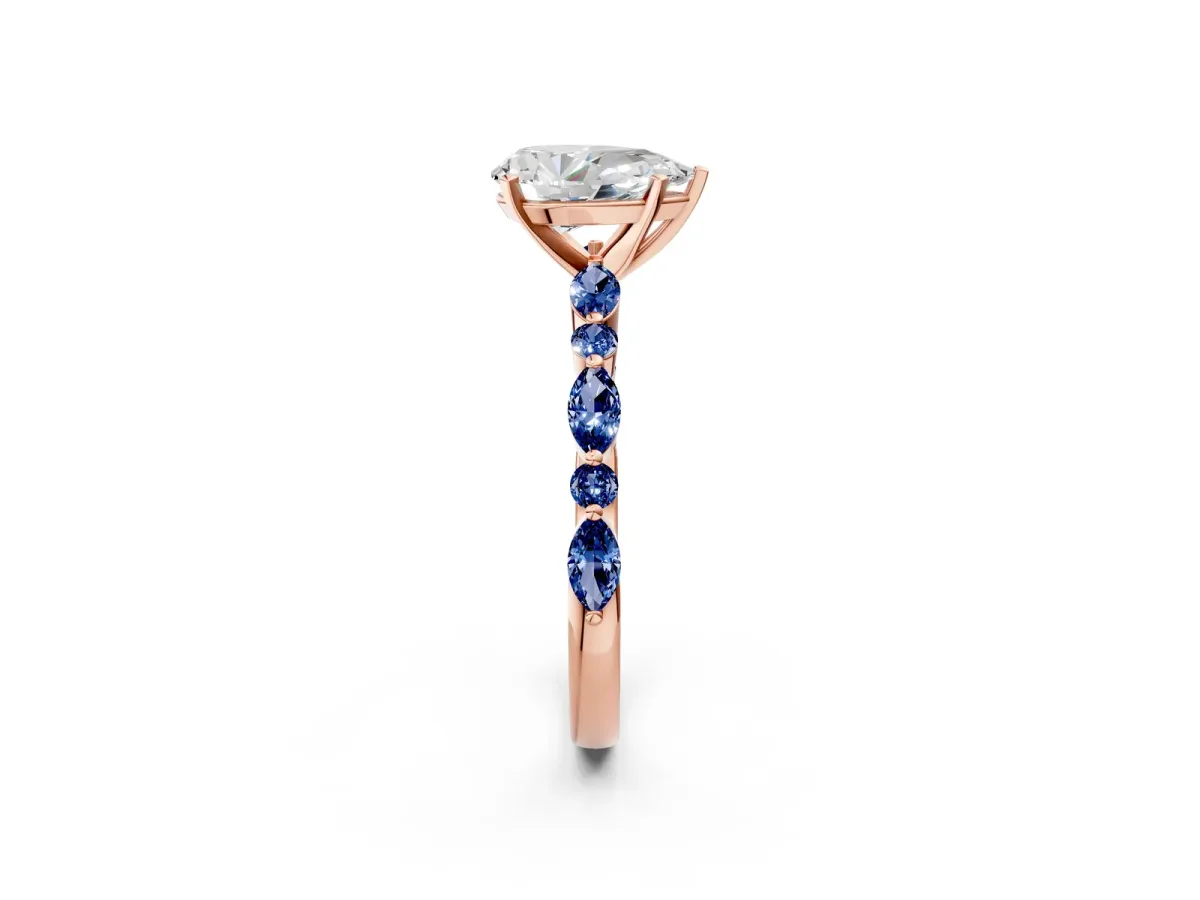 Pear Cut Diamond Ring with Marquise and Round Blue Sapphire Side Stones and Four-Prong Setting Rose gold