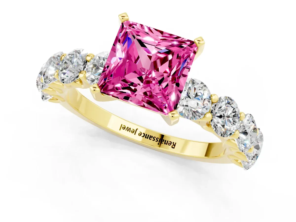 Princess Cut Pink Sapphire Prong Setting with Side Stones on a Pave Band Yellow gold
