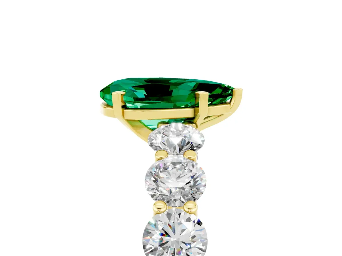 Pear Cut Emerald Prong Setting with Side Stones on a Pave Band Yellow gold