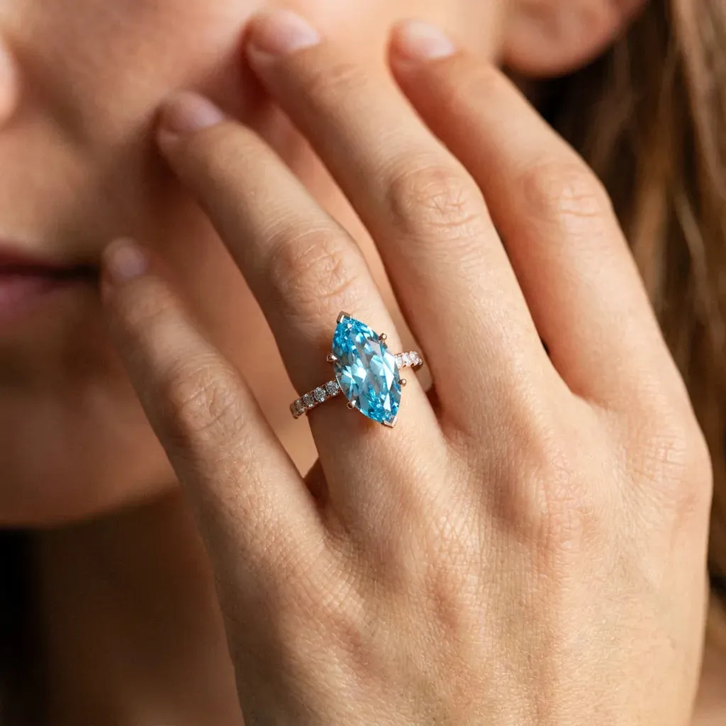 Marquise Cut Blue Topaz Solitaire Ring with Round Pavé Band and Four-Prong Setting Rose gold