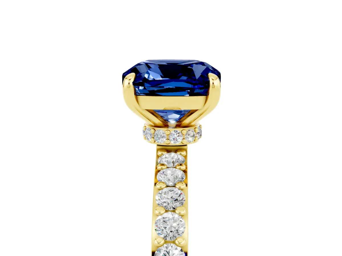 Cushion Cut Blue Sapphire Solitaire Engagement Ring with Pavé Band and Four-Prong Setting Yellow gold