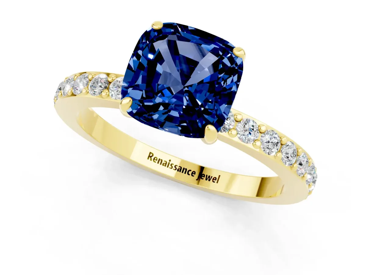 Cushion Cut Blue Sapphire Solitaire Engagement Ring with Pavé Band and Four-Prong Setting Yellow gold