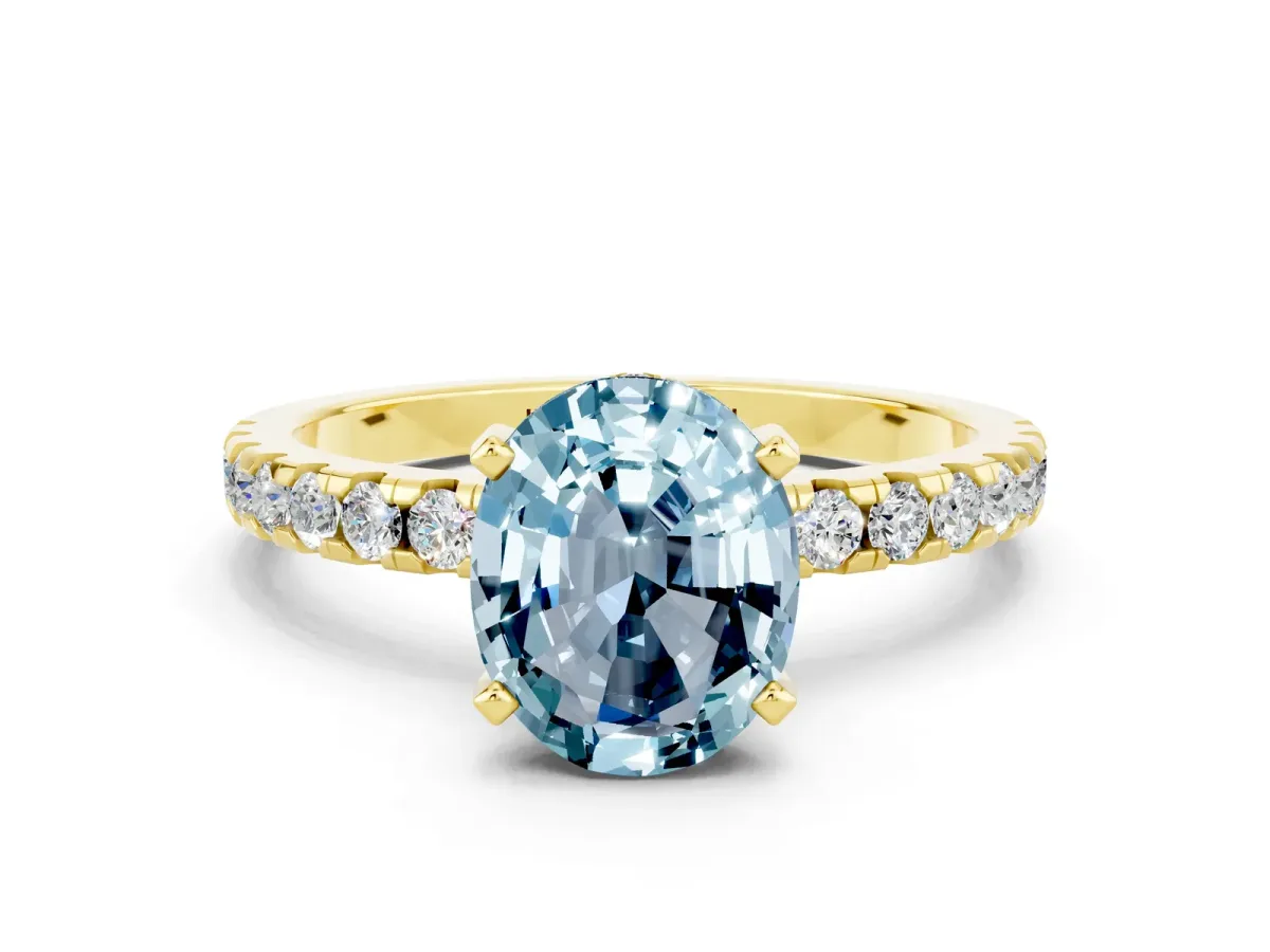 Oval Cut Aquamarine Solitaire Ring with Round Pavé Band and Four-Prong Setting Yellow gold
