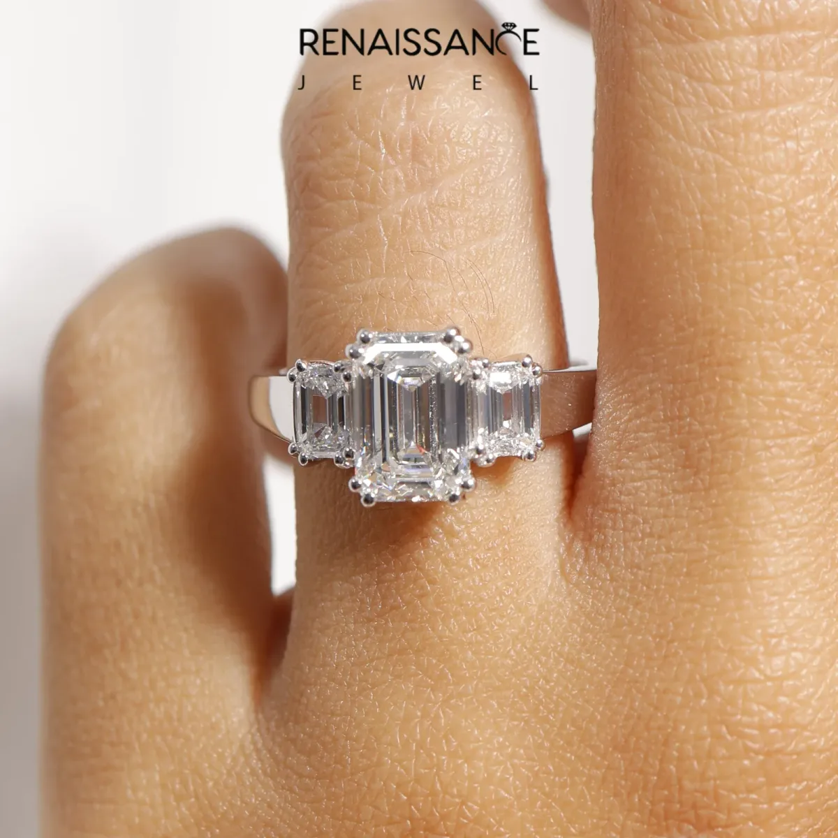 Three-Stone Emerald Cut Cut Diamond Ring with Channel Set Band and Four-Prong Setting Platinum
