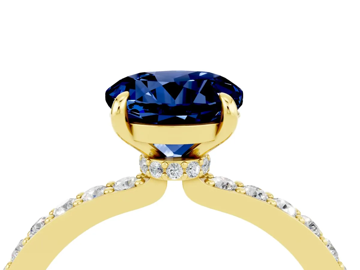 Round Cut Blue Sapphire Solitaire Engagement Ring with Pavé Band and Four-Prong Setting Yellow gold