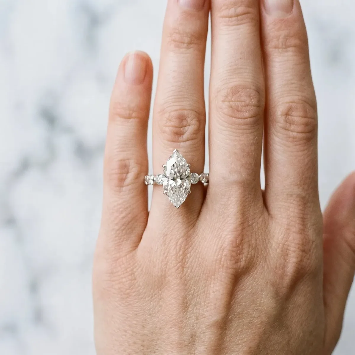 Marquise Cut Solitaire Diamond Ring with Pave Band and Four-Prong Setting Platinum