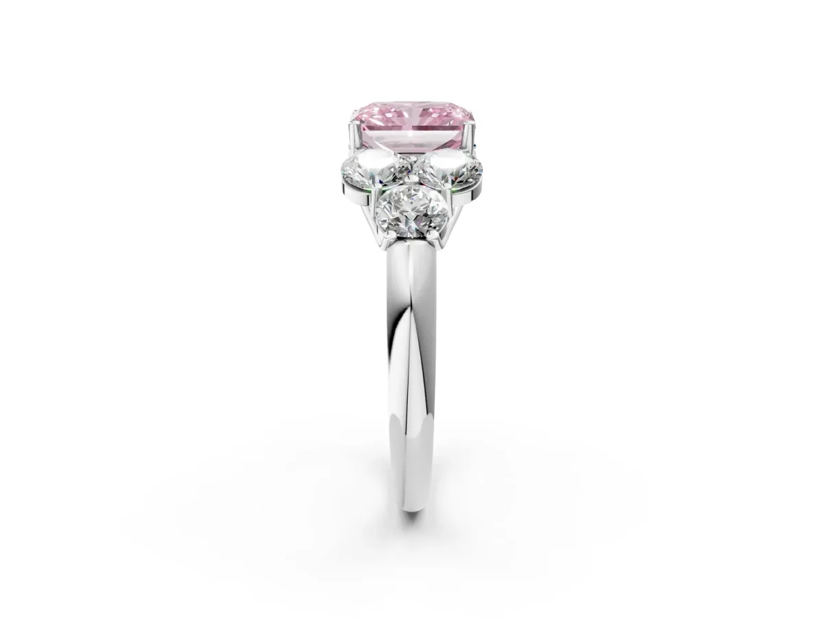 Fancy Pink Radiant Cut Cut Diamond Cluster Ring with Round Accent Stones and Prong Setting on a Classic Band Platinum