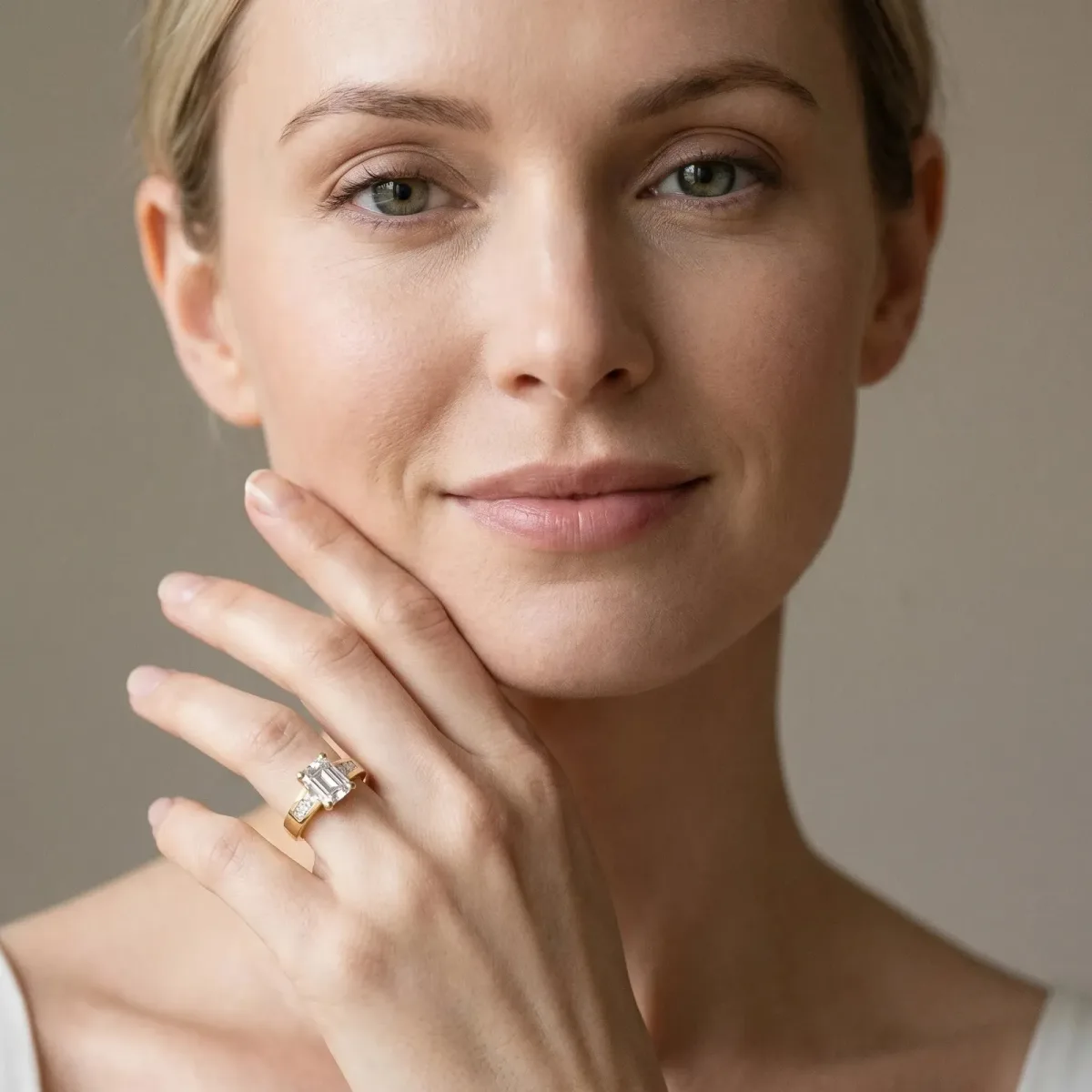 Emerald Cut Cut Channel Set Solitaire Ring with Four-Prong Setting Yellow gold