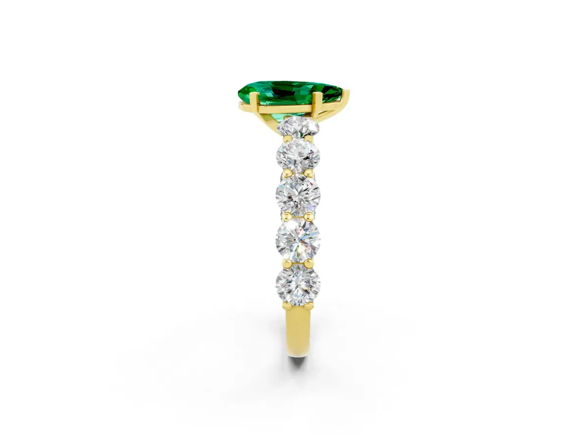 Pear Cut Emerald Prong Setting with Side Stones on a Pave Band Yellow gold