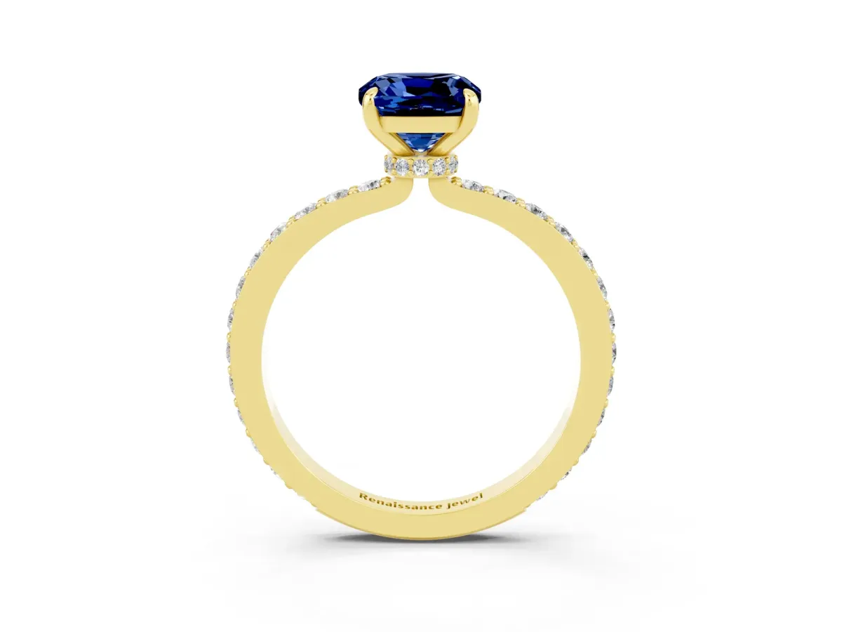 Cushion Cut Blue Sapphire Solitaire Engagement Ring with Pavé Band and Four-Prong Setting Yellow gold