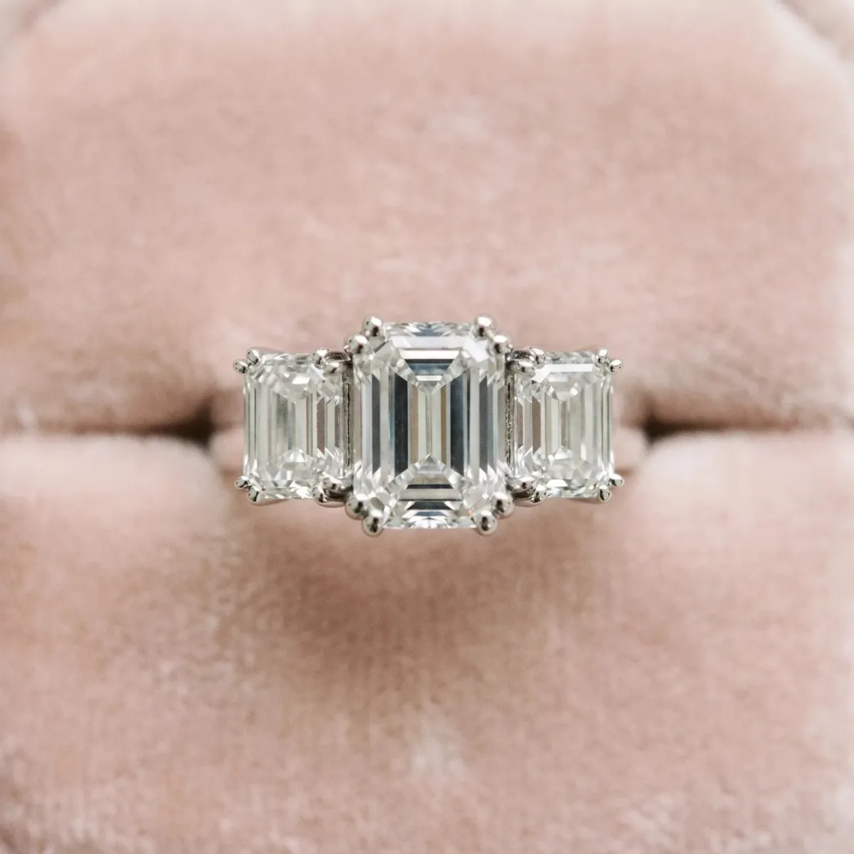 Three-Stone Emerald Cut Cut Diamond Ring with Channel Set Band and Four-Prong Setting Platinum