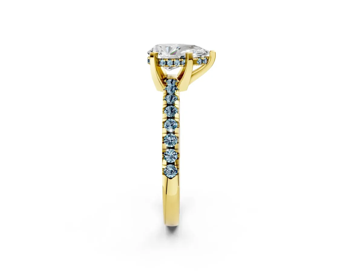 Pear Cut Diamond Solitaire Ring with Round Aquamarine Pavé Band and Four-Prong Setting Yellow gold