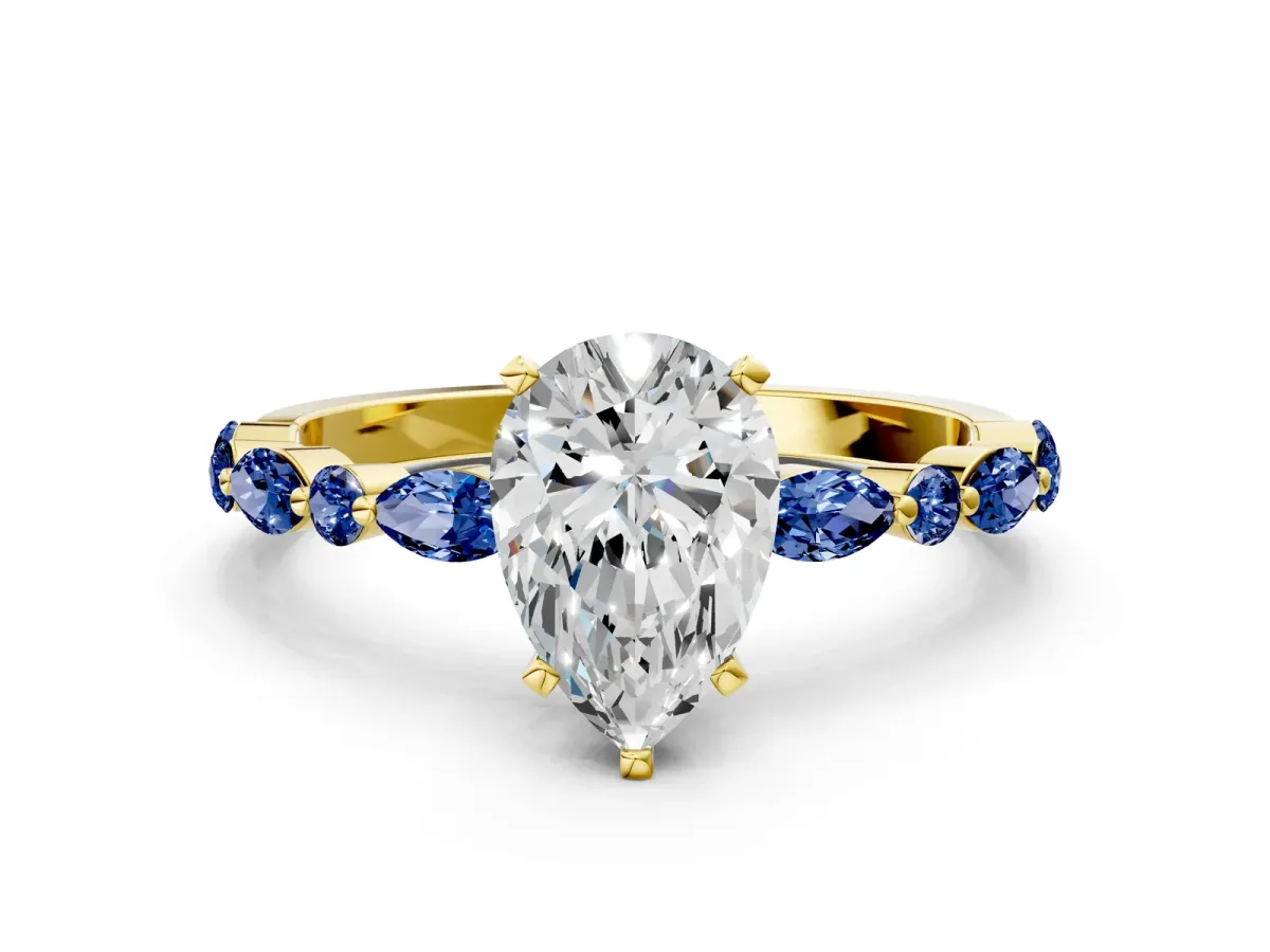 Pear Cut Diamond Ring with Marquise and Round Blue Sapphire Side Stones and Four-Prong Setting Yellow gold