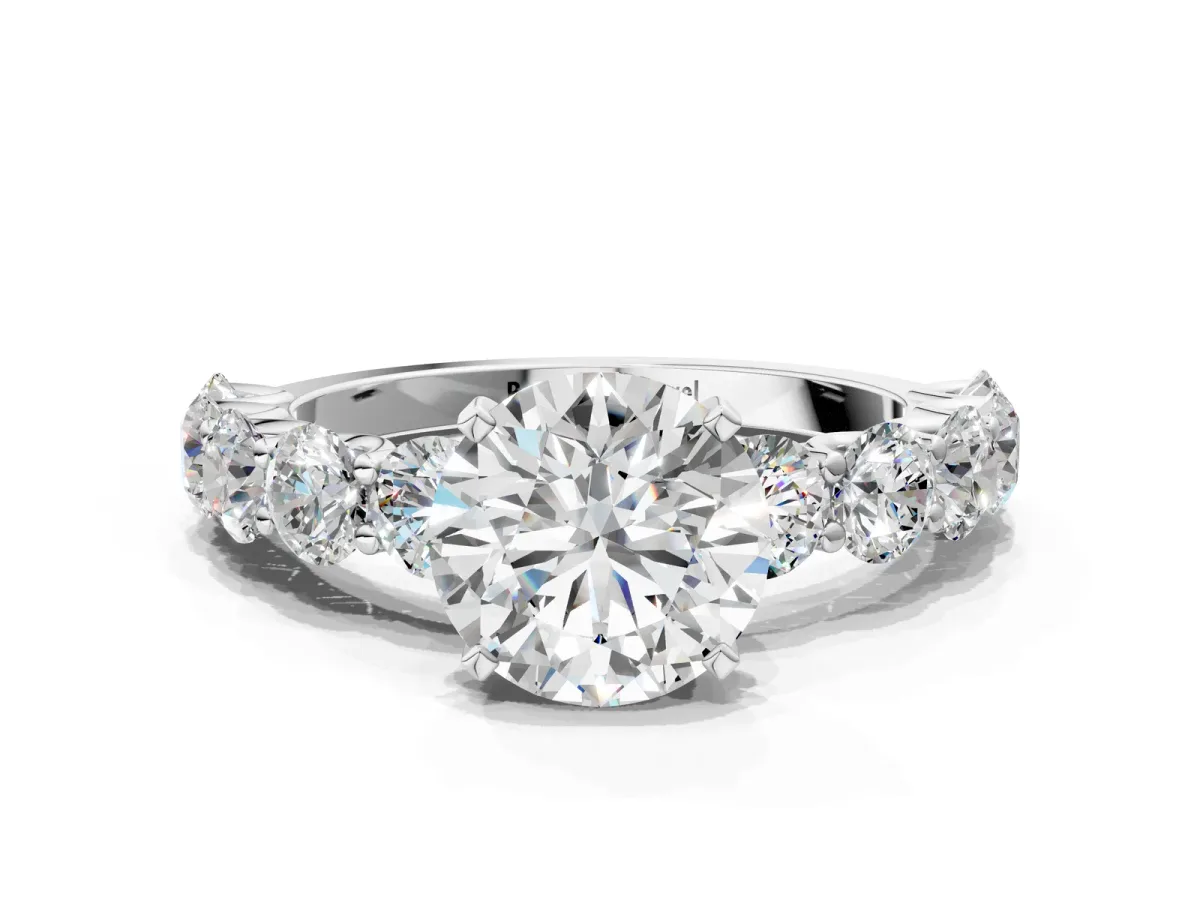 Round Cut Diamond Prong Setting with Side Stones on a Pave Band White gold