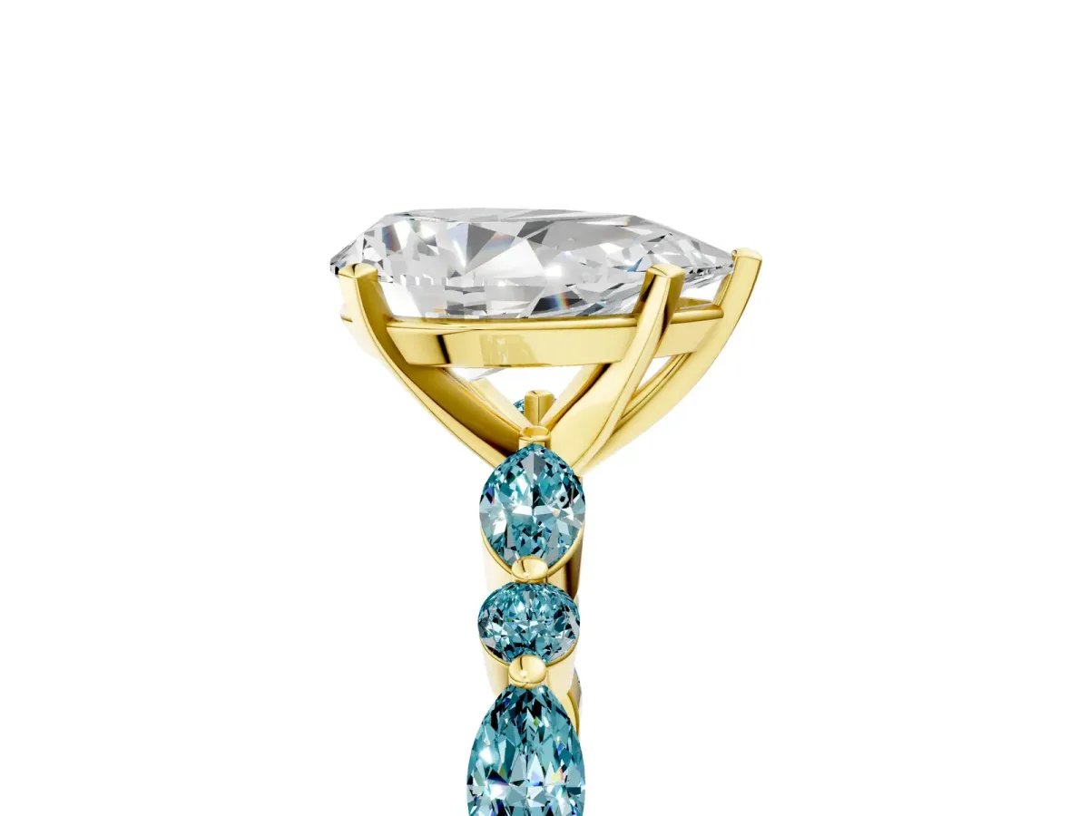 Pear Cut Diamond Ring with Marquise and Round Blue Topaz Side Stones and Four-Prong Setting Yellow gold