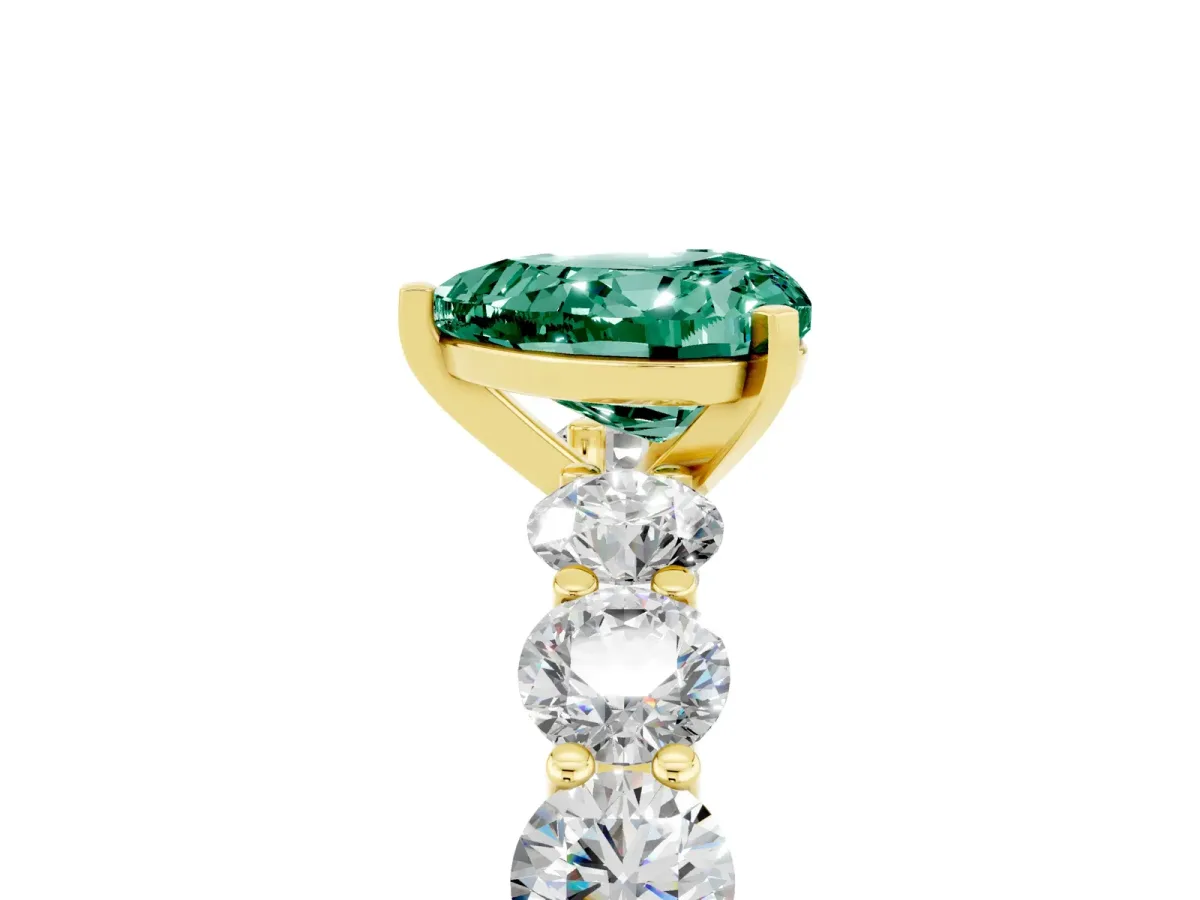 Heart Cut Green Sapphire Prong Setting with Side Stones on a Pave Band Yellow gold