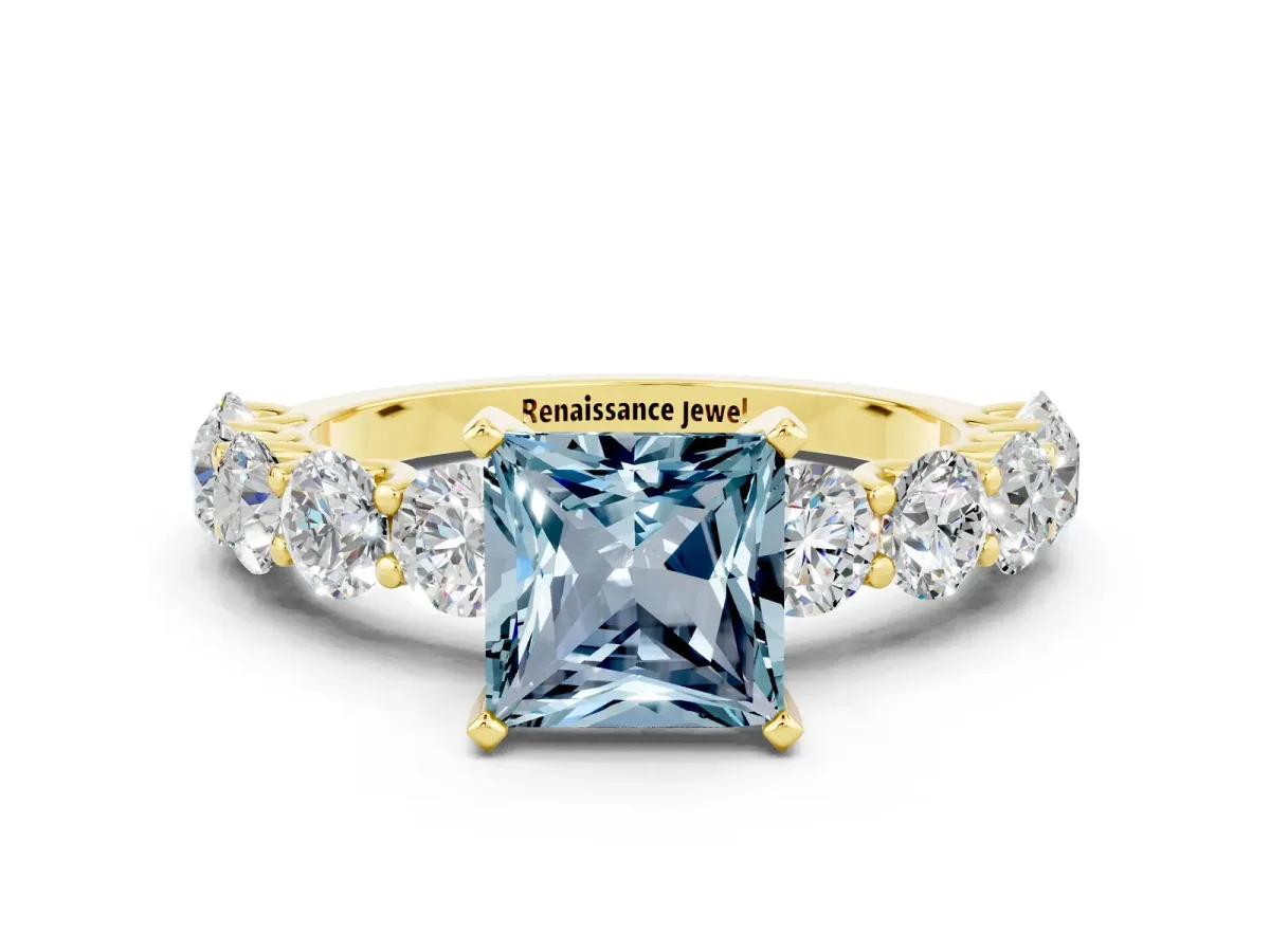 Princess Cut Aquamarine Prong Setting with Side Stones on a Pave Band Yellow gold