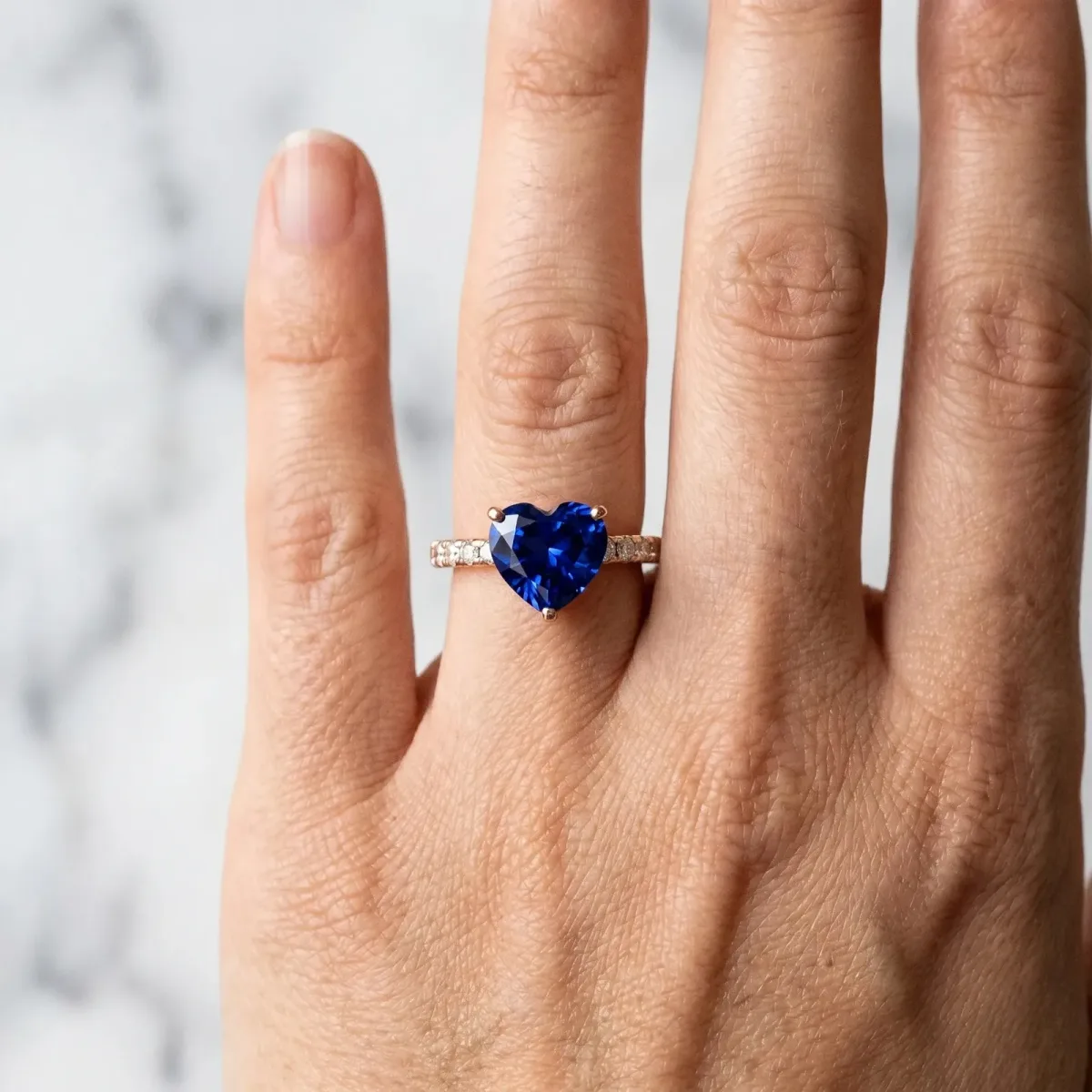 Heart Cut Blue Sapphire Solitaire Ring with Round Pavé Band and Four-Prong Setting Rose gold