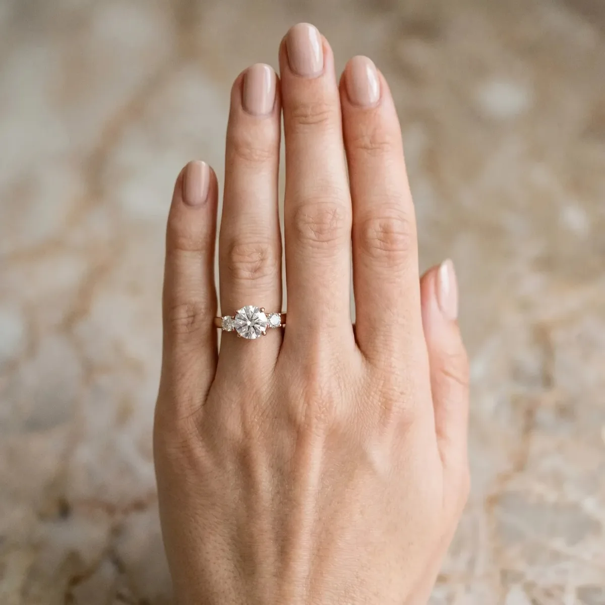 Three-Stone Marquise Cut Diamond Solitaire with Round Accents and Prong Setting on a Classic Band Rose gold