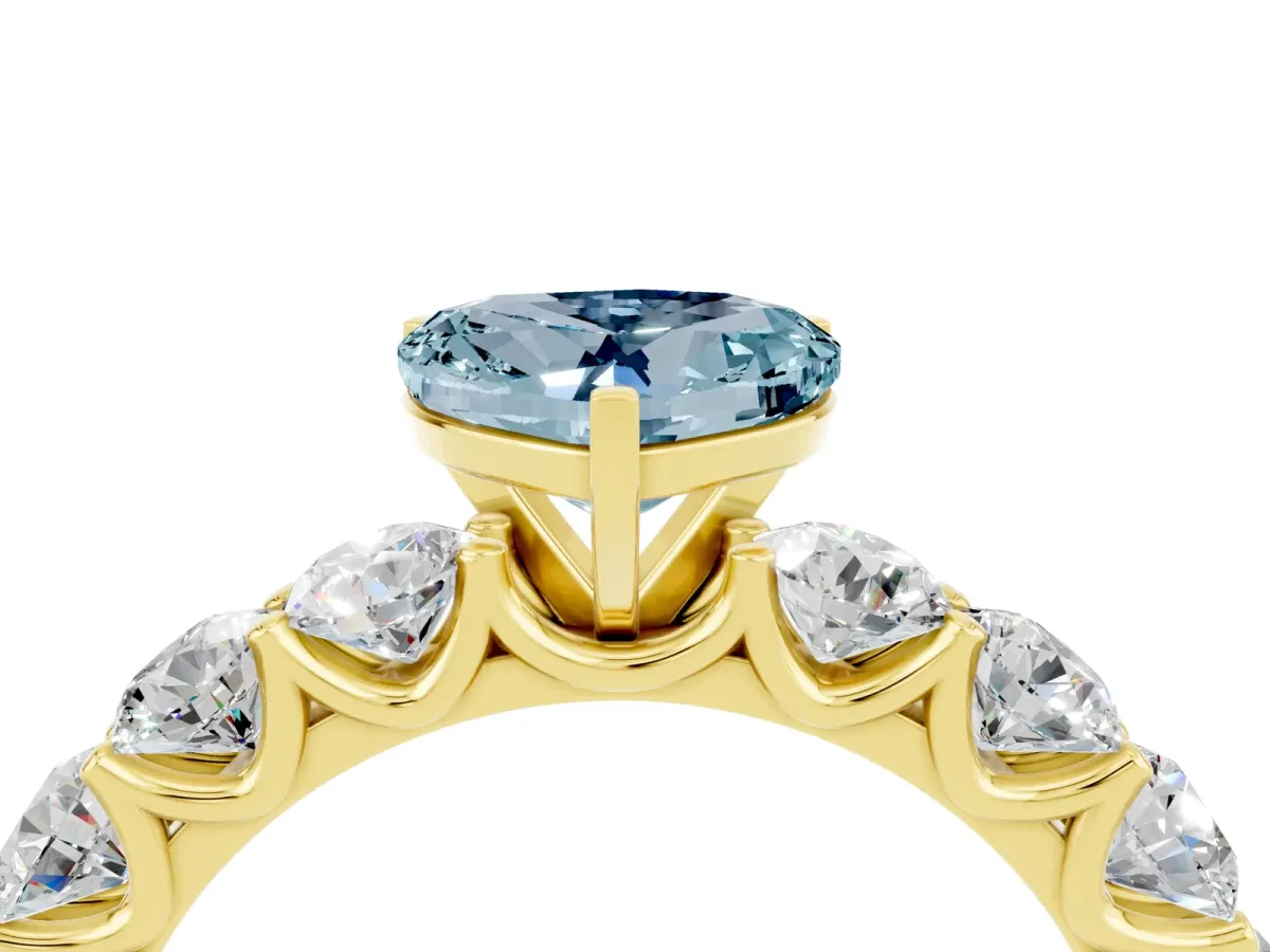 Heart Cut Aquamarine Prong Setting with Side Stones on a Pave Band Yellow gold