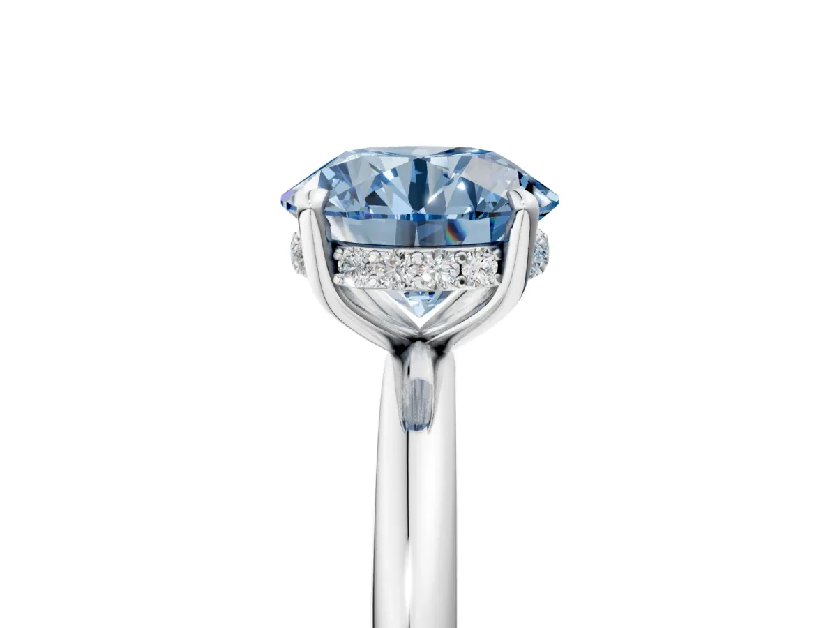Fancy Blue Round Cut Diamond Solitaire Ring with Thin Band and Four-Prong Setting Silver
