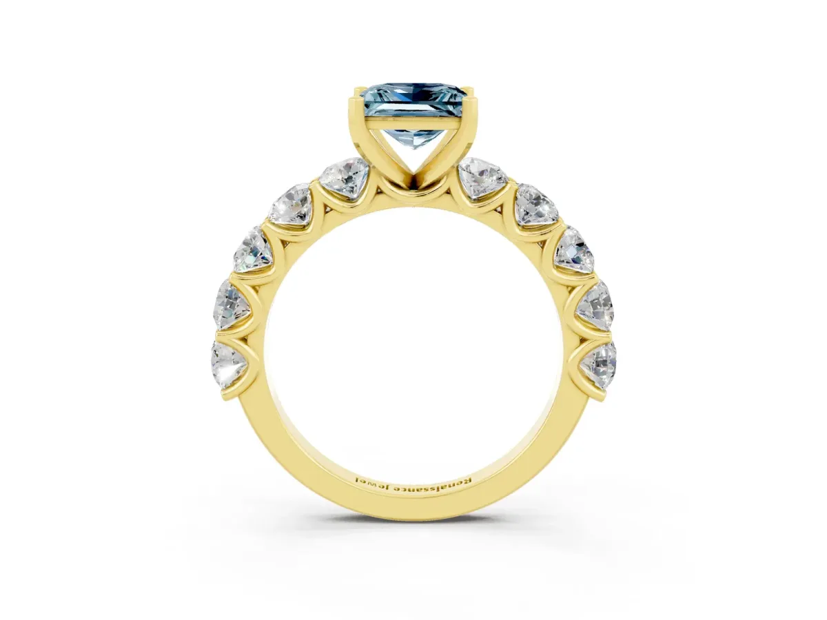 Princess Cut Aquamarine Prong Setting with Side Stones on a Pave Band Yellow gold